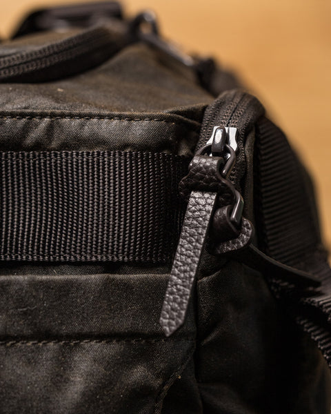 Close up of leather zips on KNKG Waxed Canvas Duffel 