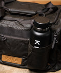Close up of drink bottle inside pocket of KNKG Waxed Canvas Duffel 