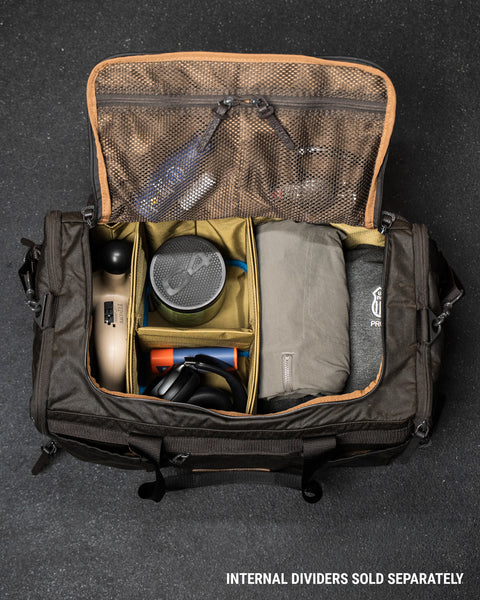 Open KNKG Waxed Canvas Duffel birds eye view of packed bag with gym essentials 